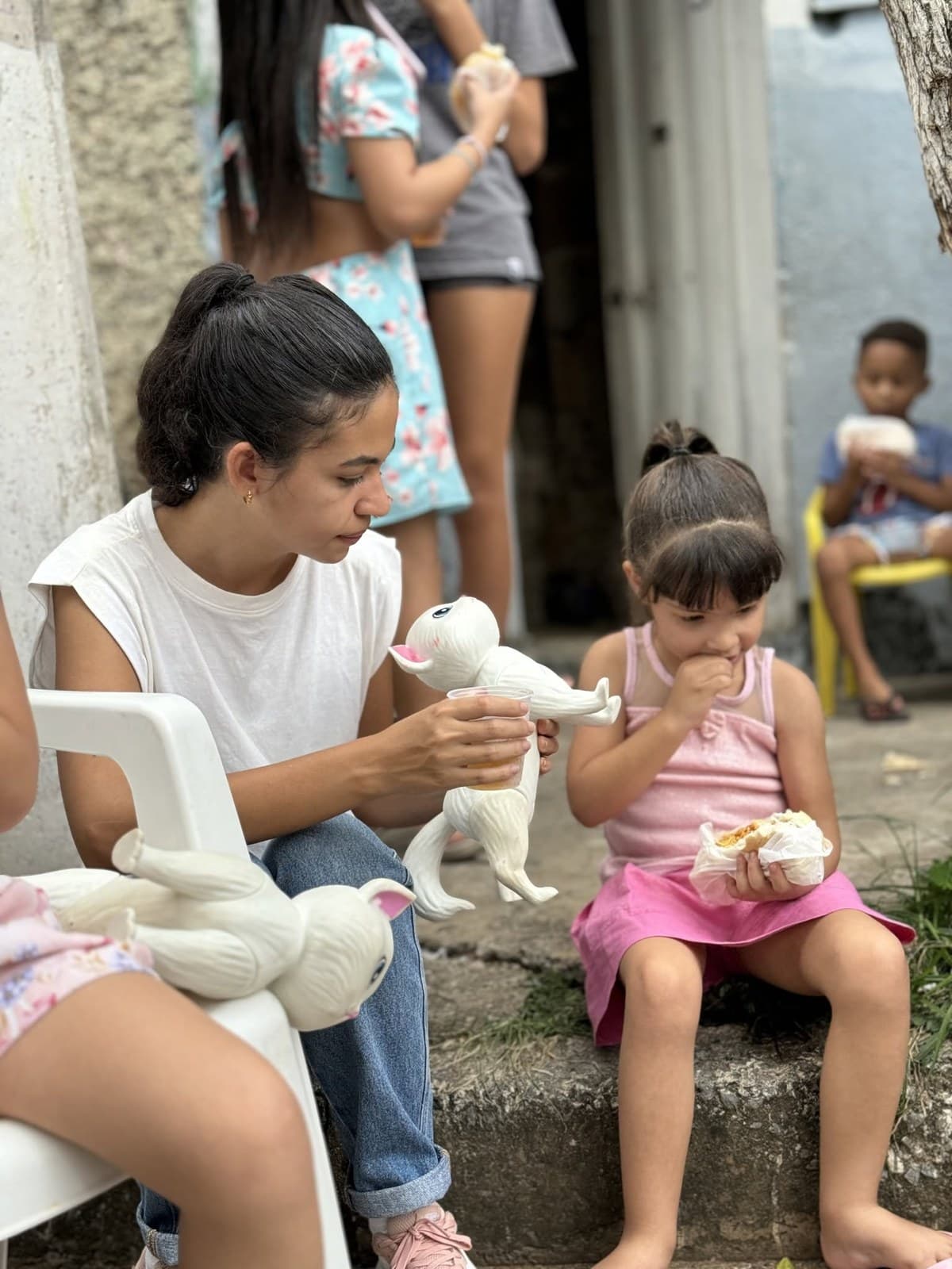 Sharing a moment with a toy during a community gathering in Brazil.